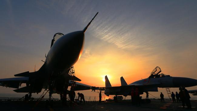 J15 fighter jets on China's operational aircraft carrier, the Liaoning, during a drill at sea. Picture: AFP.