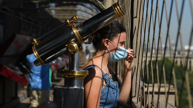 A tourist on the first floor of the Eiffel Tower for its partial reopening in Paris. Picture: Getty Images