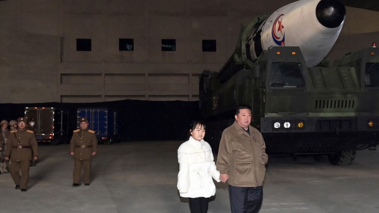 A North Korean propaganda photo showing Kim Jong-un on a daddy-daughter day out to see an ICBM launch with a girl believed to be his middle child Kim Ju-ae. Picture: KCNA