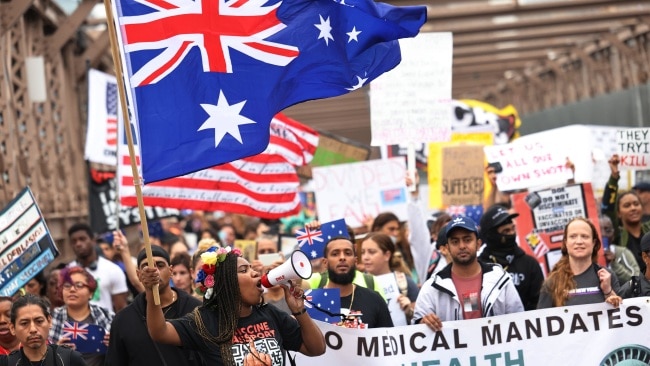 Protesters could be seen waving the Australian flag and chanting "save Australia" as US educators rallied against the vaccine mandate that came into effect on Monday. Picture: Michael M. Santiago/Getty Images