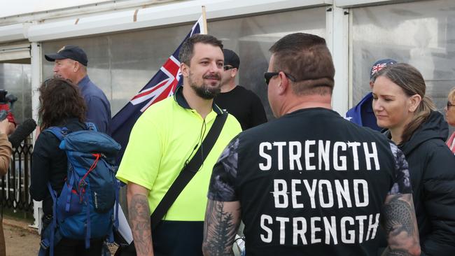 Anti-immigration organiser Neil Erikson (yellow shirt) on the St Kilda foreshore. Picture: David Crosling/AAP