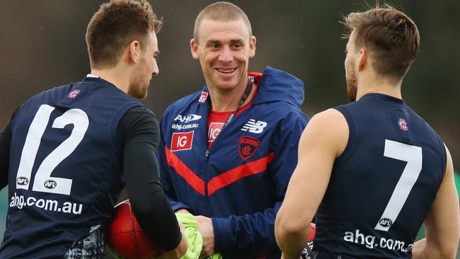 Jack Viney (right) chats with Simon Goodwin and Dom Tyson (left) at Melbourne training. Picture: Getty Images.