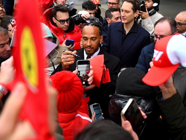 FIORANO MODENESE, ITALY - JANUARY 20: Sir Lewis Hamilton greets fans during his first official days as a Scuderia Ferrari F1 driver at Fiorano Circuit as John Elkann, CEO of Exor, looks on, on January 20, 2025 in Fiorano Modenese, Italy.  (Photo by Rudy Carezzevoli/Getty Images) *** BESTPIX ***