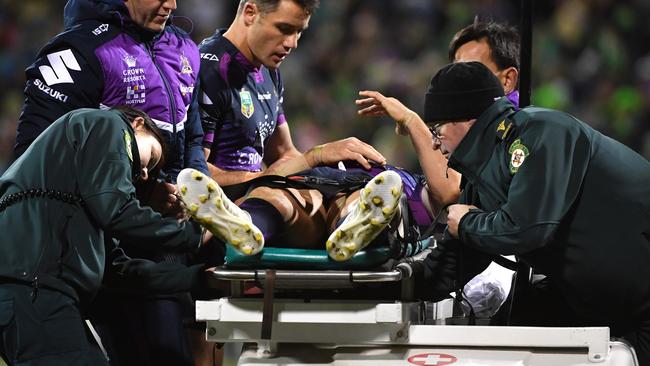 Billy Slater of the Storm is carried off the field after being knocked out during the Round 20 NRL match between the Canberra Raiders and the Melbourne Storm at GIO Stadium in Canberra, Saturday, July 22, 2017. (AAP Image/Mick Tsikas) NO ARCHIVING, EDITORIAL USE ONLY