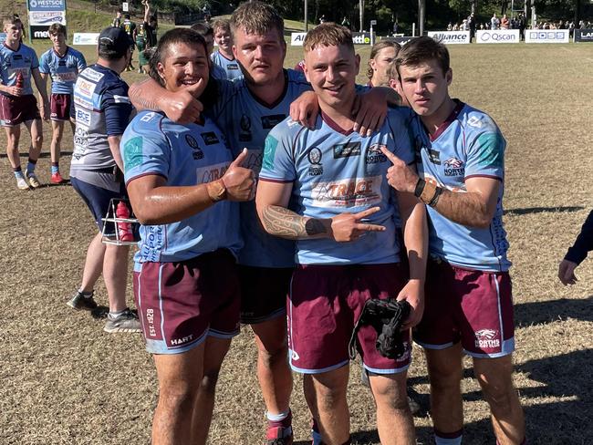 Norths players celebrate their win.