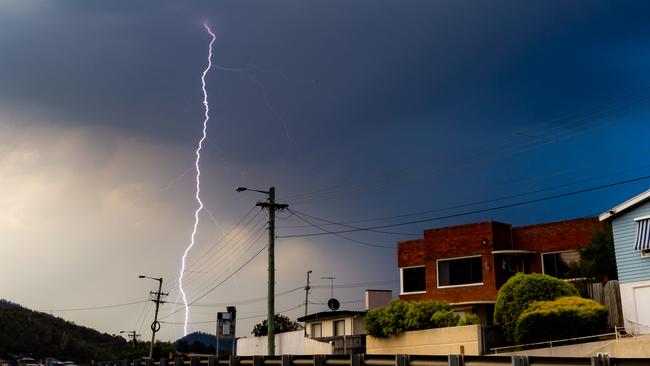 Lightning lit up the sky around Hobart, including this strike near Mt Direction, as seen from Lindisfarne. Picture: BEN SHORT