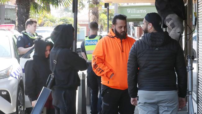 People gather outside the targetted shop. Picture: David Crosling