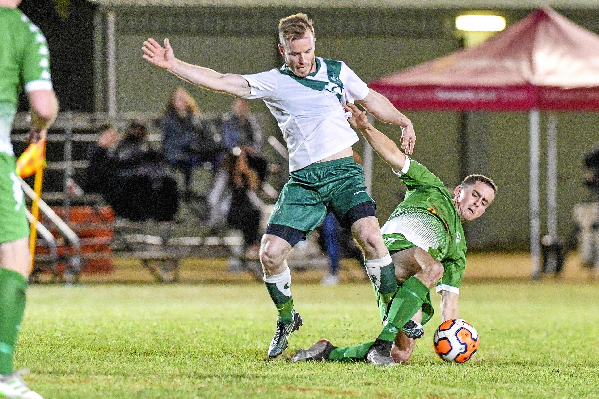 Clinton FC vs frenchville in the Central Queensland Premier League, division one. PICTURED: Clinton's Ryan Crawford and Frenchville's Jordan Miller. Picture: Matt Taylor GLA030819SOCC
