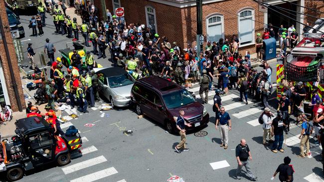 People receive first-aid after a car ran into a crowd of protesters in Charlottesville. Picture: AFP/Paul J Richards