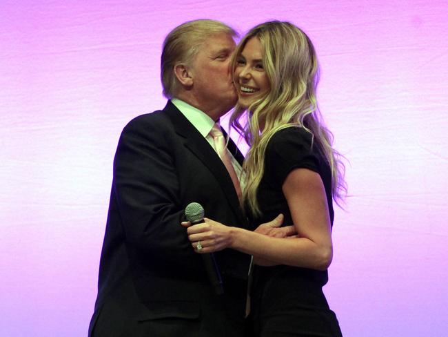 Businessman Donald Trump gives former Miss Universe Jennifer Hawkins a hug, after she introduced him as the guest speaker at the National Achievers Conference at the Sydney Entertainment Centre in Darling Harbour, Sydney.