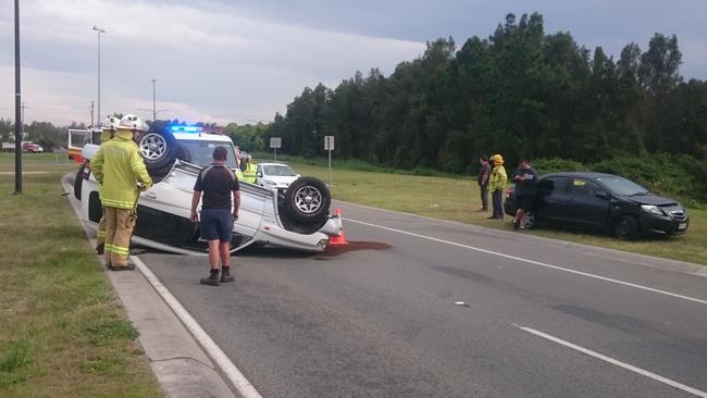 The 4WD on its roof and the other vehicle involved in the crash. Photo: Jerad Williams