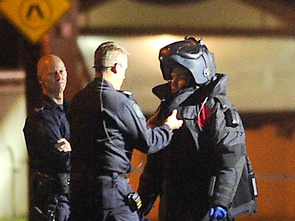 Police getting into a bomb suit. Police on scene in Sandgate were  a suspicious device was found.Saturday October 17, 2020. Picture, John Gass.