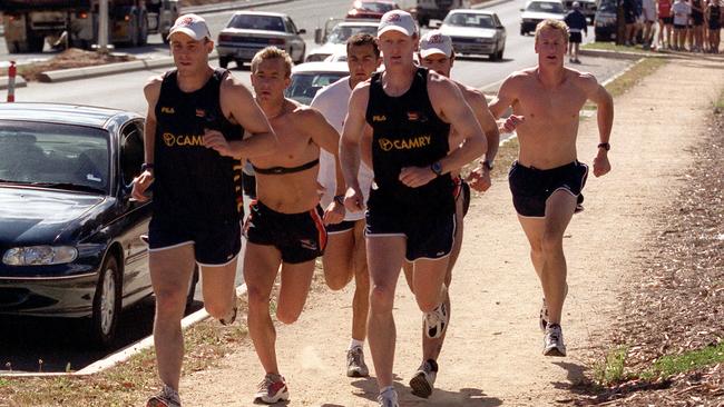 Melbourne coach Simon Goodwin, left, leads his Adelaide Crows teammates on running hill climb sprints during a pre-season training session on Robe Tce, Medindie in 2001.