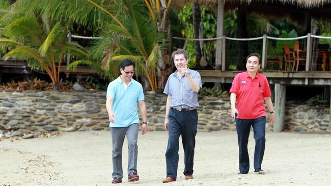 Previous Double Island owner Sean Howard, (centre) with current owner Benny Wu when the island changed hands in 2012. Picture: Tom Lee