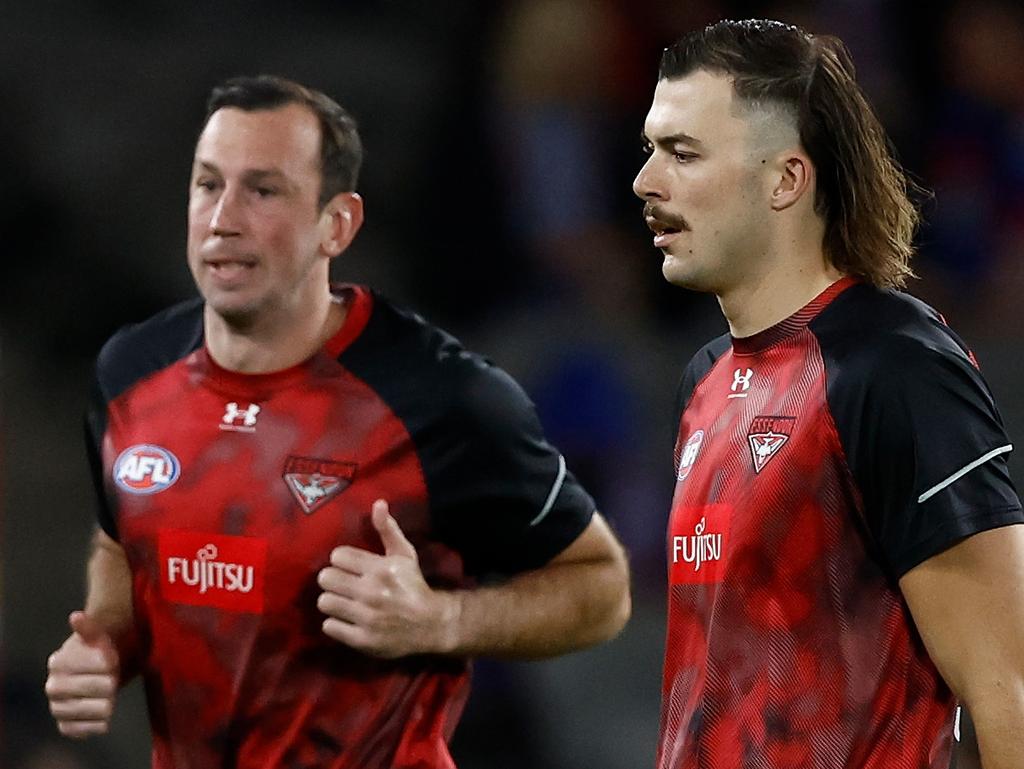 MELBOURNE, AUSTRALIA - APRIL 12: Todd Goldstein (left) and Sam Draper of the Bombers warm up during the 2024 AFL Round 05 match between the Western Bulldogs and the Essendon Bombers at Marvel Stadium on April 12, 2024 in Melbourne, Australia. (Photo by Michael Willson/AFL Photos via Getty Images)