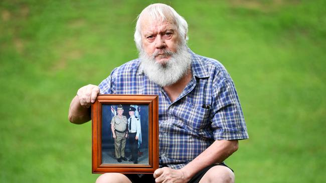 Peter Angus, father of LAC Jamie Angus who died by suicide at the RAAF base Amberley in 2009 holding a photo of the pair from his RAAF graduation. Picture: Alix Sweeney