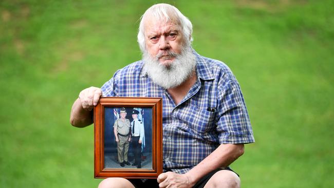 Peter Angus, father of LAC Jamie Angus who died by suicide at the RAAF base Amberley in 2009 holding a photo of the pair from his RAAF graduation. Picture: Alix Sweeney