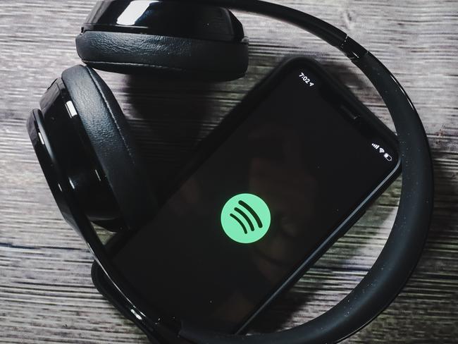 An iphone 11 screen showing spotify icon with beats earphone, perfect for listening musics on the go