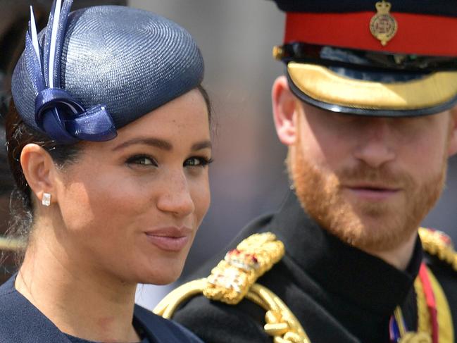 (FILES) In this file photo taken on June 08, 2019 Britain's Meghan, Duchess of Sussex (L) and Britain's Prince Harry, Duke of Sussex (R) return to Buckingham Palace after the Queen's Birthday Parade, 'Trooping the Colour', in London. - Britain's Queen Elizabeth II on January 13, 2020, said Prince Harry and his wife Meghan would be allowed to split their time between Britain and Canada while their future is finalised. The couple said last week they wanted to step back from the royal frontline, catching the family off guard and forcing the monarch to convene crisis talks about the pair's future roles. (Photo by Daniel LEAL-OLIVAS / AFP)