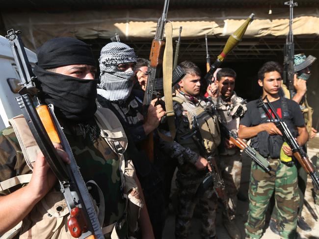 Iraqi Shiite Turkmen gunmen gather on Friday. Picture: AP Photo/Hussein Malla