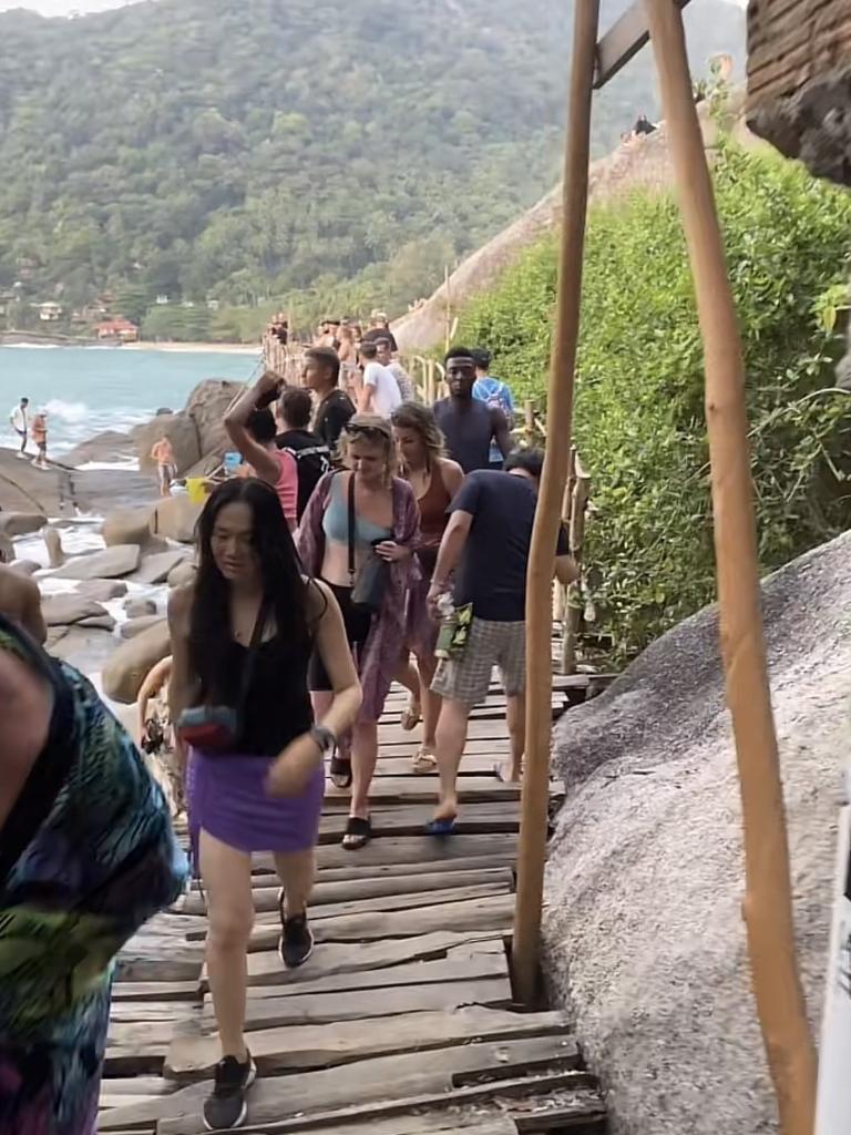 Partygoers navigate a small walkway to get across the rocks. Picture: TikTok/@mesu_diye