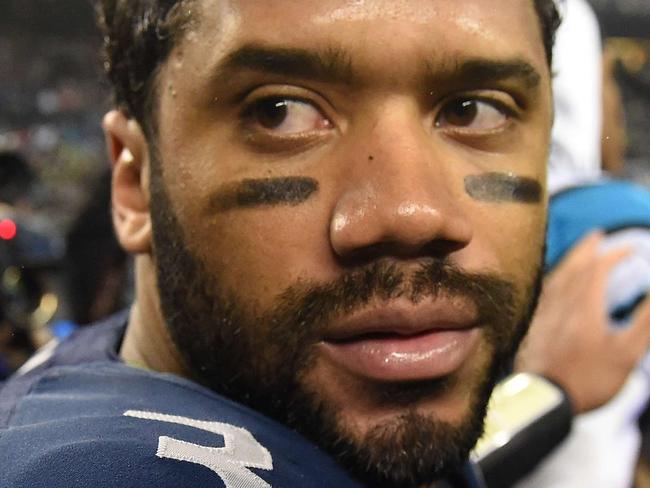SEATTLE, WA - JANUARY 10: Russell Wilson #3 of the Seattle Seahawks looks on prior to shaking hands with Cam Newton #1 of the Carolina Panthers after their 2015 NFC Divisional Playoff game at CenturyLink Field on January 10, 2015 in Seattle, Washington. The Seattle Seahawks defeated the Carolina Panthers 31 to 17. Steve Dykes/Getty Images/AFP == FOR NEWSPAPERS, INTERNET, TELCOS & TELEVISION USE ONLY ==