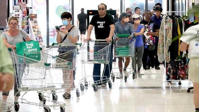 Shoppers queue outside Woolworths at West Torrens in Adelaide, South Australia on Wednesday. Picture: Getty Images