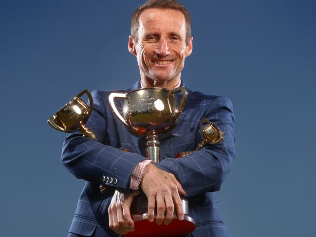 MELBOURNE , AUSTRALIA. October 29, 2023.  Champion jockey Damien Oliver with the 3 Melbourne Cups he has won on Doriemus (1995), Media Puzzle (2002) and Fiorente (2013) near his home in Port Melbourne.      . Pic: Michael Klein