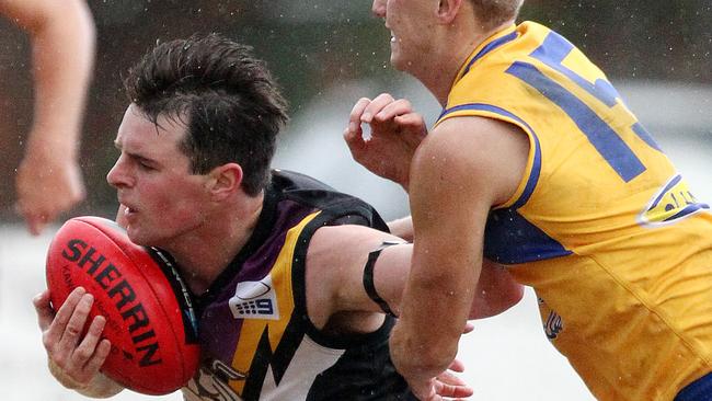 Stuart Hill attempts to break a Shayne Allan tackle. Picture: Sarah Matray