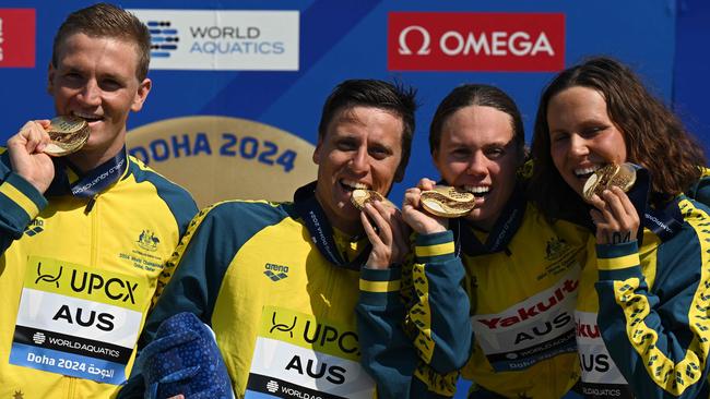 Team Australia pose with their gold medals after the final of the mixed 4X1500m relay open water event. (Photo by Oli SCARFF / AFP)