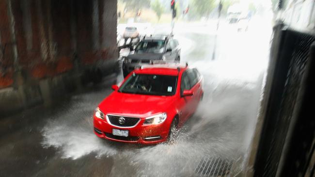 A car drives under the rail bridge on Dudley street in Melbourne.