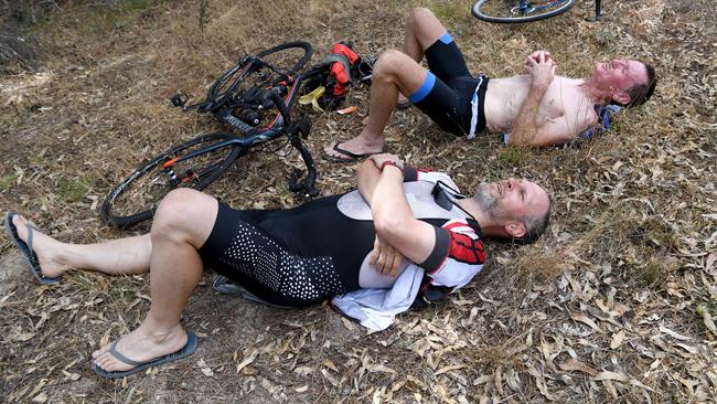 Scott Nicholas and Murray McPherson from Melbourne crash out in the heat as they wait for the peloton. Picture: Tricia Watkinson