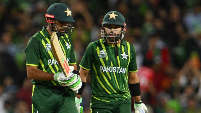 Pakistan's Muhammad Rizwan (R) speaks with Pakistan's Captain Babar Azam after his dismissal during the ICC men's Twenty20 World Cup 2022 semi-final cricket match between New Zealand and Pakistan. (Photo by Saeed KHAN / AFP)