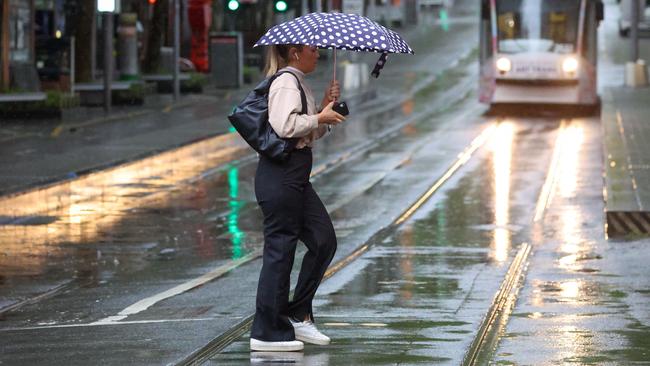 People have been braving the wet weather in Melbourne. Picture: NCA NewsWire / Brendan Beckett