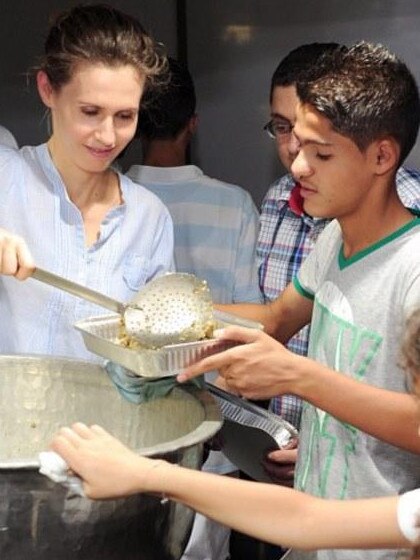 Asma serves food to orphans and displaced families in Damascus in 2013. Picture: Supplied