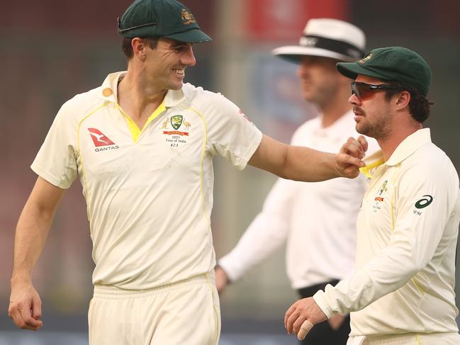 DELHI, INDIA - FEBRUARY 17: Pat Cummins speaks with Travis Head of Australia as they walk off the ground at the end of play during day one of the Second Test match in the series between India and Australia at Arun Jaitley Stadium on February 17, 2023 in Delhi, India. (Photo by Robert Cianflone/Getty Images)