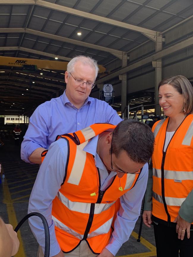 Prime Minister Scott Morrison signing a high vis vest of a Neumann Steel employee. Photo: Emily Halloran