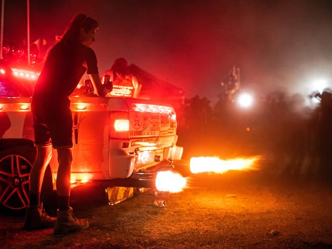 DENILIQUIN, AUSTRALIA - OCTOBER 03: A festival goer watches as a Ute backfires at the 2019 Deni Ute Muster on October 03, 2019 in Deniliquin, Australia. The annual Deniliquin Ute Muster is the largest ute muster in Australia,  attracting more than 18,000 people to the rural town of Deniliquin together to celebrate all things Australian and the icon of the Ute in a weekend of music, competitions and camping. (Photo by James Gourley/Getty Images)