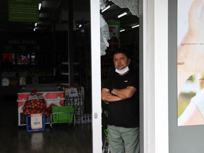 Manager Zafar Aziz shows the damage where a thief smashed into West Gladstone Foodworks just after 4am on April 11. Picture: Rodney Stevens