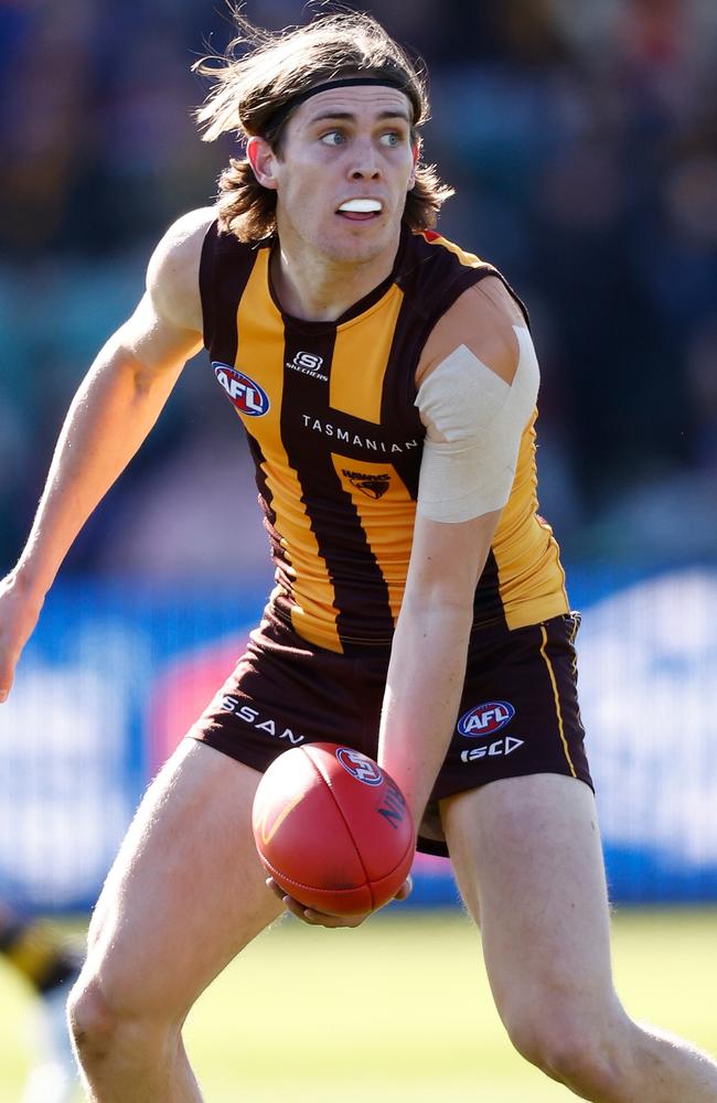 Will Day sweeps a handball. Picture: Michael Willson/AFL Photos