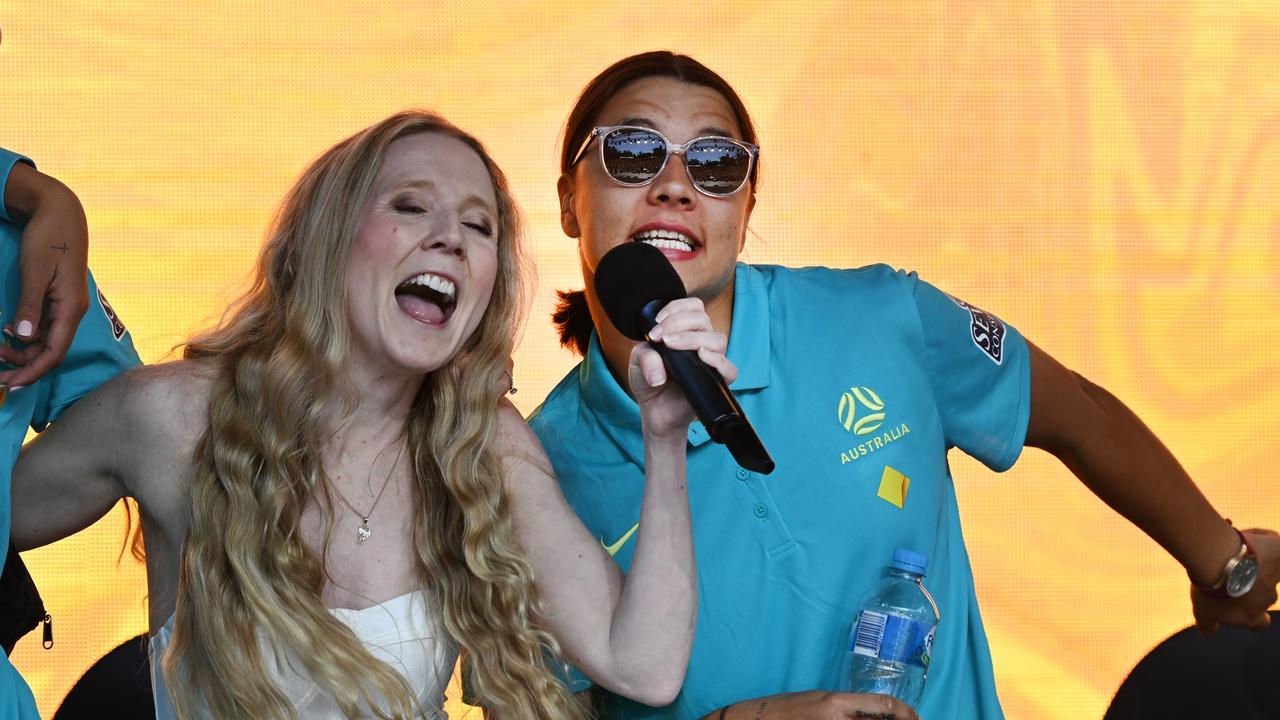 Sam Kerr sings with Nikki Webster as Matildas fans gather to show their support at a community reception event in Brisbane. Picture: Dan Peled / NCA NewsWire