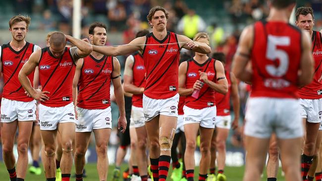 Essendon players leave the ground after their loss. Picture: Getty Images