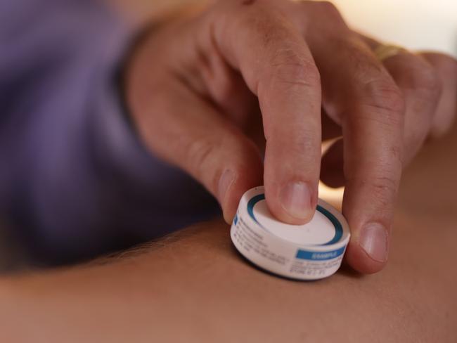 Dr David Muller of UQ with the vaccine patch that could deliver a Covid-19 vaccine