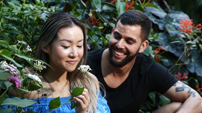 Tanya Li and Hugo Lima admire the flowers in bloom at the Cairns Botanic Gardens. PICTURE: BRENDAN RADKE