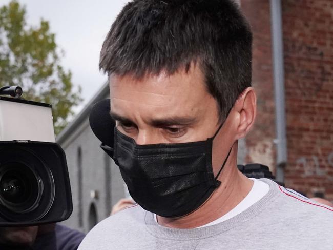 Richard Pusey, the driver of a Porsche who allegedly fled the scene of a truck crash on Melbourne's Eastern Freeway which killed four police officers, is taken away from his Fitzroy property by police in Melbourne, Thursday, April 23, 2020. (AAP Image/Michael Dodge) NO ARCHIVING