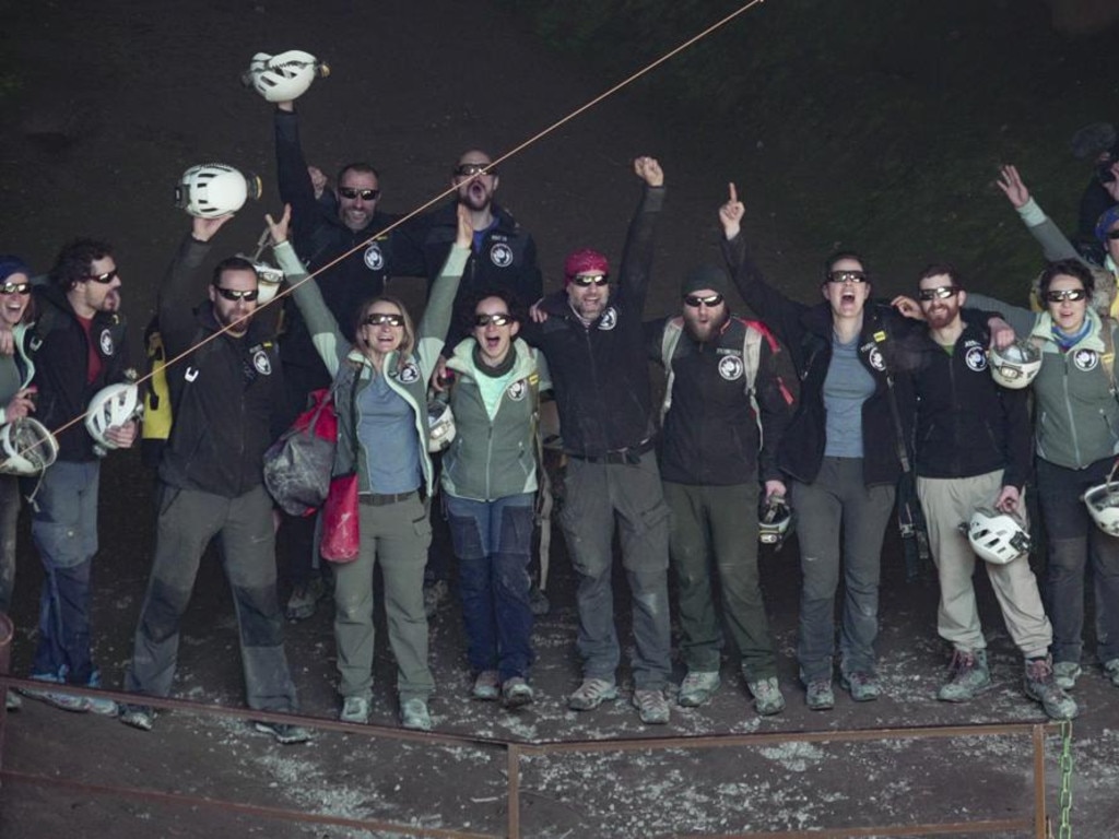 Members of the French team that participated in the "Deep Time" study, celebrate as they emerge from the Lombrives Cave after 40 days underground in Ussat les Bains, France, Saturday, April 24, 2021.After 40 days in voluntary isolation, 15 people participating in a scientific experiment have emerged from a vast cave in southwestern France. Eight men and seven women lived in the dark, damp depths of the Lombrives cave in the Pyrenees to help researchers understand how people adapt to drastic changes in living conditions and environments. They had no clocks, no sunlight and no contact with the world above. (AP Photo/Renata Brito)