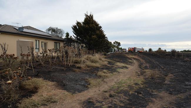 The grassfire reached properties on Rowell Place in Taylors Lakes. Picture: Josie Hayden