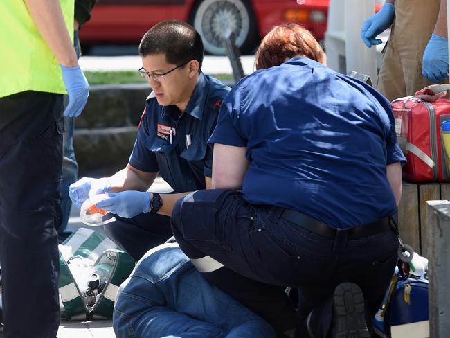 Paramedics work on a man for a suspected overdose on Lennox St. Picture: Nicole Garmston