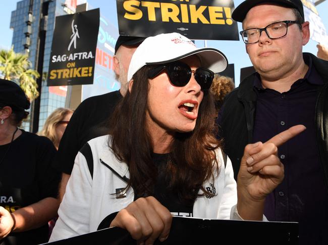 SAG-AFTRA President Fran Drescher, with National Executive Director & Chief Negotiator, Duncan Crabtree-Ireland (R), joins Writers Guild members at a picket line outside Netflix in Los Angeles on July 14, 2023. Tens of thousands of Hollywood actors went on strike at midnight July 13, 2023, effectively bringing the giant movie and television business to a halt as they join writers in the first industry-wide walkout for 63 years. (Photo by VALERIE MACON / AFP)