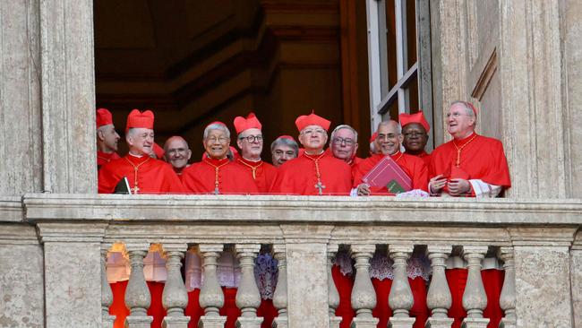 Cardinals react from a balcony of the St Peter's Basilica, as the new pope makes his first appearance. Picture: AFP